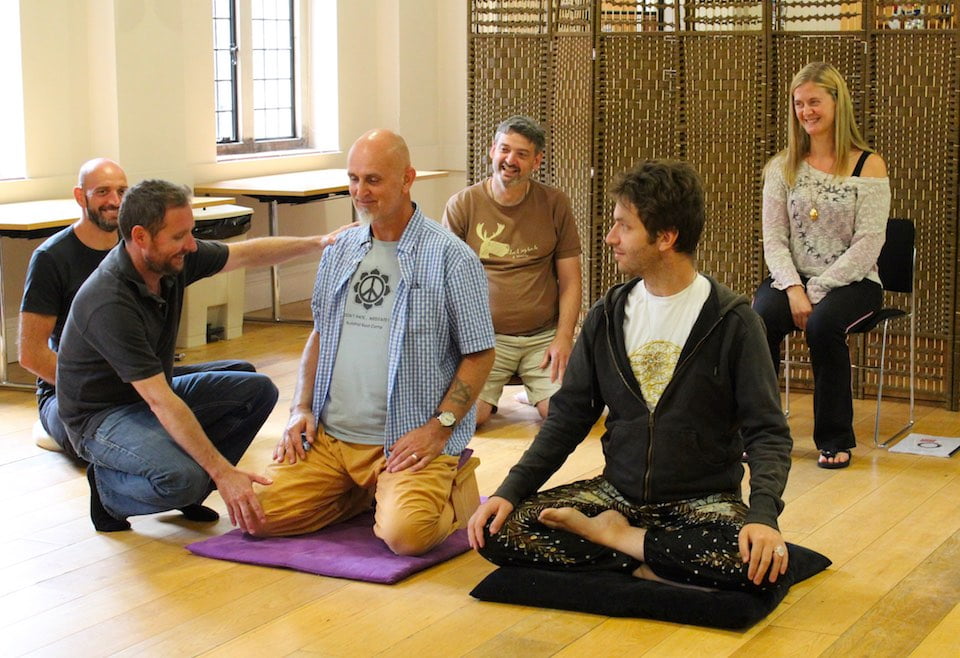Meditation and Mindfulness Teacher Training group adjusting posture