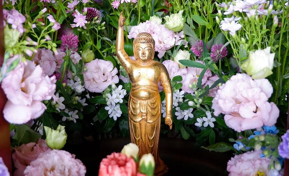 Hanamatsuri golden buddha and flowers